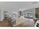 Spacious living room with pool view features a comfortable seating arrangement and modern decor at 977 N Doral Ln, Venice, FL 34293