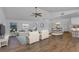 Bright and spacious living area with comfortable seating, hardwood floors, and open layout at 977 N Doral Ln, Venice, FL 34293