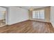 Open living room with ample natural light, new floors, and elegant chandelier at 977 N Doral Ln, Venice, FL 34293