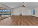 Spacious living room featuring sliding glass doors to the pool area and wood-look flooring at 977 N Doral Ln, Venice, FL 34293
