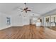 Bright living room featuring vaulted ceiling, modern ceiling fan, and wood-look flooring at 977 N Doral Ln, Venice, FL 34293