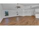 Open-concept living room with hardwood floors and abundant natural light from large windows at 977 N Doral Ln, Venice, FL 34293