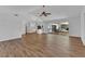 Spacious living room with vaulted ceiling, wood floors, and sliding doors to the outdoor patio at 977 N Doral Ln, Venice, FL 34293