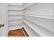 Walk-in pantry with white shelving for ample storage at 977 N Doral Ln, Venice, FL 34293