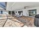Covered outdoor patio featuring tile flooring, a fan, and access to the pool area at 977 N Doral Ln, Venice, FL 34293
