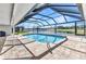 View of screened pool and golf course views with tile flooring at 977 N Doral Ln, Venice, FL 34293