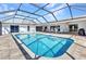 View of a screened pool featuring clear blue water and access to the home's outdoor space at 977 N Doral Ln, Venice, FL 34293