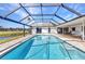 View of a beautiful screened-in pool featuring access to the home and views of the golf course at 977 N Doral Ln, Venice, FL 34293