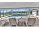 Screened pool area featuring lounge seating, golf course views, and access to the pool at 977 N Doral Ln, Venice, FL 34293
