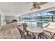Screened-in lanai with a pool, dining table, chairs, lounge chairs, and a serene view at 977 N Doral Ln, Venice, FL 34293