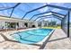 View of the lanai featuring a clear pool and a view of the greenery in the distance at 977 N Doral Ln, Venice, FL 34293