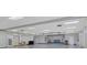 Large open auditorium with a stage, polished floors, and natural light at 985 Jolanda Cir, Venice, FL 34285