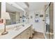 Well-lit bathroom with a walk-in shower, toilet, and vanity with a large mirror, providing ample space at 985 Jolanda Cir, Venice, FL 34285