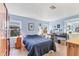 Serene bedroom with ample natural light, offers a tranquil retreat with comfortable decor and functional workspace at 985 Jolanda Cir, Venice, FL 34285
