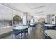 Open dining area with multiple tables and chairs, overlooking the pool and palm trees at 985 Jolanda Cir, Venice, FL 34285