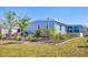 Well-maintained exterior with lush landscaping, mature trees, and an inviting patio area at 985 Jolanda Cir, Venice, FL 34285