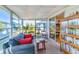 Relaxing sunroom filled with natural light, cozy seating, and views of the surrounding landscape at 985 Jolanda Cir, Venice, FL 34285