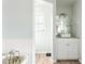 Bright bathroom featuring a single vanity, walk-in shower, and white cabinets at 1104 Larchmont Dr, Englewood, FL 34223