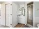 Bright bathroom featuring a single vanity, walk-in shower, and white cabinets at 1104 Larchmont Dr, Englewood, FL 34223