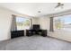 Spacious bedroom with plush carpeting, a modern desk setup, and dual windows providing ample natural light at 1104 Larchmont Dr, Englewood, FL 34223
