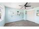 Bright bedroom with light blue walls, ceiling fan, and a window offering natural light at 1104 Larchmont Dr, Englewood, FL 34223