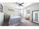 Comfortable bedroom featuring a soft bed, ceiling fan, and window with natural light at 1104 Larchmont Dr, Englewood, FL 34223