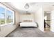 Bright bedroom with a large window, ceiling fan, neutral tones and carpet at 1104 Larchmont Dr, Englewood, FL 34223
