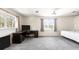 Spacious bedroom featuring two large windows, and neutral colored carpet at 1104 Larchmont Dr, Englewood, FL 34223
