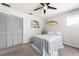 Bedroom with gray walls, a ceiling fan, and a comfortable bed with blue striped bedspread at 1104 Larchmont Dr, Englewood, FL 34223