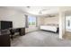 Spacious bedroom featuring a ceiling fan, soft carpet, and lots of natural light through a window at 1104 Larchmont Dr, Englewood, FL 34223