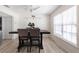 Bright dining area features wood-look tile, ceiling fan, and gray upholstered chairs for a modern, welcoming space at 1104 Larchmont Dr, Englewood, FL 34223