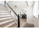 Inviting entryway with a staircase, and view to a dining area with stylish chairs at 1104 Larchmont Dr, Englewood, FL 34223
