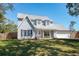 Attractive two-story home with gray siding, new roof, and a lush green front yard at 1104 Larchmont Dr, Englewood, FL 34223
