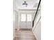 Welcoming foyer with white double doors, wood-look tile flooring, and a staircase with modern railings at 1104 Larchmont Dr, Englewood, FL 34223