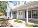 Charming home featuring a welcoming front porch and brick walkway leading to the entrance at 1104 Larchmont Dr, Englewood, FL 34223