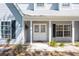 Home featuring a covered front porch with brick pavers and well-maintained landscaping at 1104 Larchmont Dr, Englewood, FL 34223