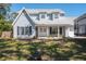 Charming two-story home with light gray siding, complemented by well-manicured front lawn at 1104 Larchmont Dr, Englewood, FL 34223