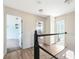 Second story landing featuring wood floors and views into the bedrooms and bathroom at 1104 Larchmont Dr, Englewood, FL 34223