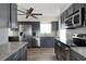 Modern kitchen with stainless appliances, gray cabinetry, and stylish backsplash for a sleek cooking space at 1104 Larchmont Dr, Englewood, FL 34223