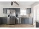 This kitchen features stainless steel appliances, gray cabinetry, and a modern design for efficient cooking at 1104 Larchmont Dr, Englewood, FL 34223