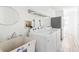 Clean laundry room featuring a washer, dryer, sink, and ample space at 1104 Larchmont Dr, Englewood, FL 34223