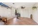 Bright living room with wood floors, ceiling fan, and a wall-mounted fish decor at 1104 Larchmont Dr, Englewood, FL 34223