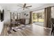Bright living room featuring a large sectional sofa, modern rug, and sliding glass doors to the outside at 1104 Larchmont Dr, Englewood, FL 34223