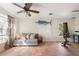 Spacious living room with tile floors, ceiling fan, and comfortable seating at 1104 Larchmont Dr, Englewood, FL 34223
