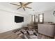 Bright living room featuring a large sectional sofa, a flat-screen TV, and a contemporary glass coffee table at 1104 Larchmont Dr, Englewood, FL 34223