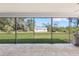 This covered screened-in patio features brick flooring and a view of the backyard at 1104 Larchmont Dr, Englewood, FL 34223