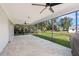 Covered screened lanai featuring brick flooring and ceiling fans, perfect for outdoor entertaining at 1104 Larchmont Dr, Englewood, FL 34223