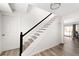 Staircase with carpeted steps and modern railings, leading to a bright and airy living space at 1104 Larchmont Dr, Englewood, FL 34223