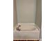 Bathroom showcasing a large soaking tub with a modern faucet and white tile surround at 13244 Doral Ave, Port Charlotte, FL 33953
