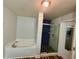 Bright bathroom featuring a soaking tub and separate glass shower with modern blue tile accents at 13244 Doral Ave, Port Charlotte, FL 33953